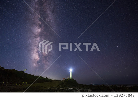 Upright galaxy and white lighthouse 129275842