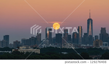 Harvest moon rises over city skyline. A beautiful celestial moon, a big moon Harvest moon rises over city skyline. A beautiful celestial moon, a big moon 129276408