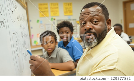 A dedicated teacher explains a concept to attentive students in a lively classroom 129277881