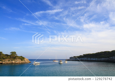 beautiful ships and boats are moored near the shore beautiful ships and boats are moored near the shore 129278742