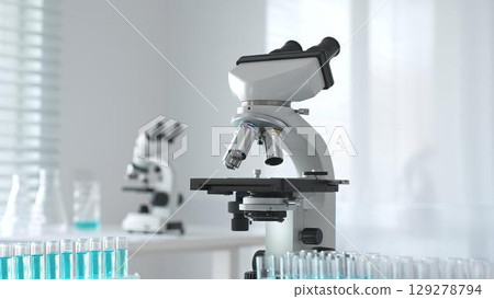 Modern microscopes and test tubes containing blue liquid are arranged on a table in a bright laboratory setting, ready for scientific research and analysis Modern microscopes and test tubes containing blue liquid are arranged on a table in a bright laboratory setting, ready for scientific research and analysis 129278794
