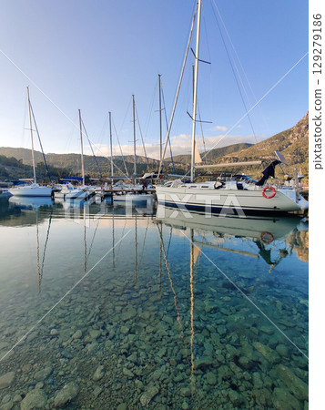 beautiful ships and boats are moored near the shore 129279186