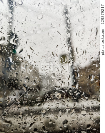 close-up of raindrops falling on a window during rain close-up of raindrops falling on a window during rain 129279217