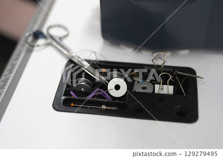 close-up of tailor's scissors and other accessories for sewing clothes close-up of tailor's scissors and other accessories for sewing clothes 129279495