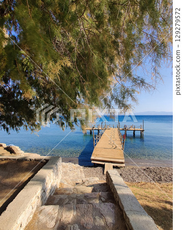 a beautiful wooden pier on the seashore for walkinga beautiful wooden pier on the seashore for walking a beautiful wooden pier on the seashore for walkinga beautiful wooden pier on the seashore for walking 129279572