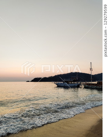 beautiful ships and boats are moored near the shore 129279599