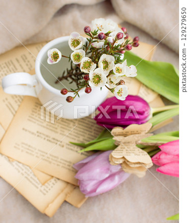 a beautiful arrangement of a bouquet of tulip flowers and a book a beautiful arrangement of a bouquet of tulip flowers and a book 129279650