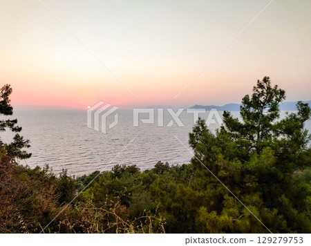 beautiful sunset on the sea with a red sun on the horizon beautiful sunset on the sea with a red sun on the horizon 129279753