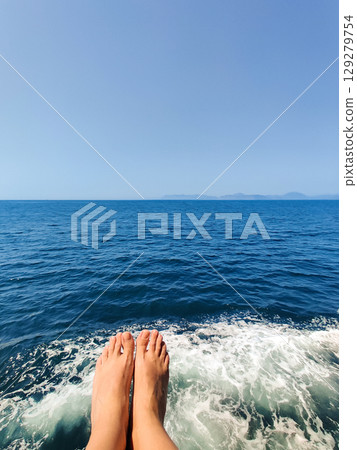 close-up of legs on the background of the sea close-up of legs on the background of the sea 129279754