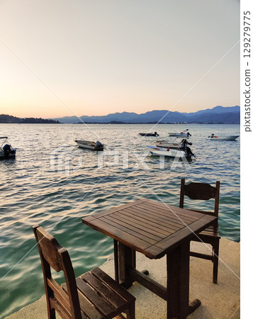 beautiful ships and boats are moored near the shore beautiful ships and boats are moored near the shore 129279775