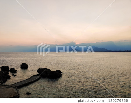beautiful seascape on the horizon silhouette of mountains 129279866