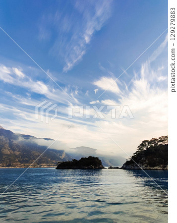beautiful seascape on the horizon silhouette of mountains 129279883