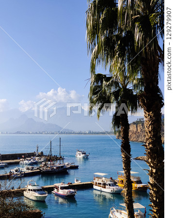 beautiful ships and boats are moored near the shore 129279907