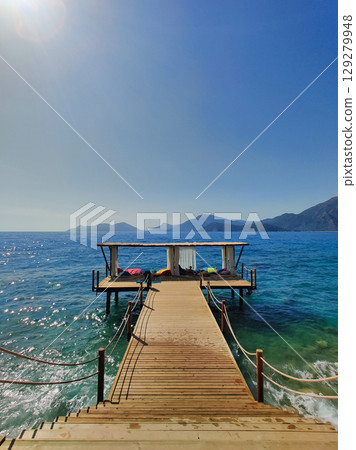 beautiful bungalows for relaxation in the middle of the water with a path from the beach 129279948