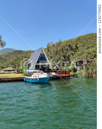 beautiful ships and boats are moored near the shore beautiful ships and boats are moored near the shore 129279962