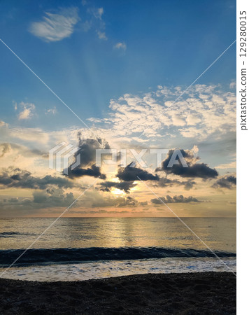 beautiful dramatic landscape of sunset on the sea beach 129280015