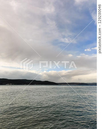 beautiful seascape on the horizon silhouette of mountains 129280046