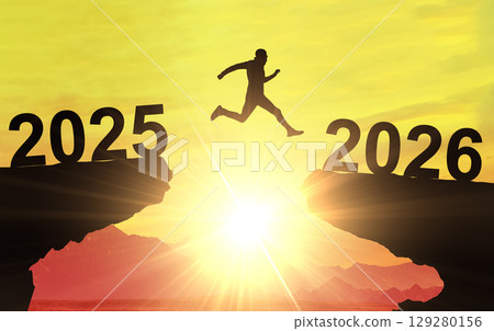 Man jumping from year 2025 to 2026, a concept of new beginnings, future success, and positive business change 129280156