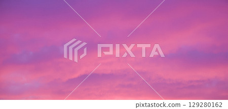 serene sunset over the sea with the sun partially hidden by clouds, creating a beautiful pink and purple sky serene sunset over the sea with the sun partially hidden by clouds, creating a beautiful pink and purple sky 129280162