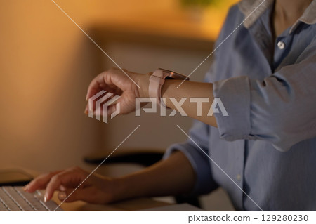 Smart Technology. Individual checking smartwatch while working. 129280230