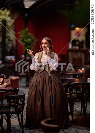 beautiful woman scientist in retro style with smoking pipe beautiful woman scientist in retro style with smoking pipe 129280676