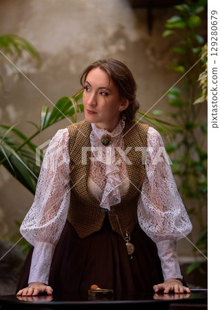 beautiful woman scientist in retro style with magnifying glass beautiful woman scientist in retro style with magnifying glass 129280679