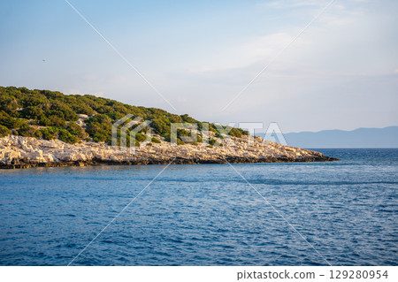 Uninhabited islands of the Lastovo National Park surrounded by calm sea in Croatia. Nature reserve, remote landscape and Mediterranean summer escape 129280954
