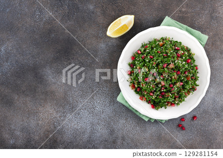 Levantine vegetarian salad with quinoa, tomatoes, pomegranate, parsley, lemon and dressing. Macro. Tabbouleh salad. Levantine vegetarian salad with quinoa, tomatoes, pomegranate, parsley, lemon and dressing. Macro. Tabbouleh salad. 129281154