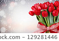 Colorful bouquet of tulips tied with a red ribbon set against a soft, sparkling background for celebrations 129281446