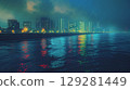 Nighttime waterfront view of a modern city with neon reflections on water under a cloudy sky 129281449