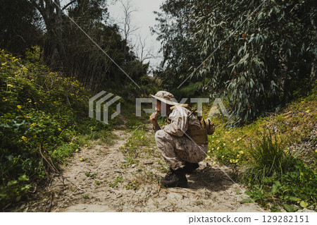 Mercenary Soldier Looking For Enemy Tracks In The Nature Mercenary Soldier Looking For Enemy Tracks In The Nature 129282151