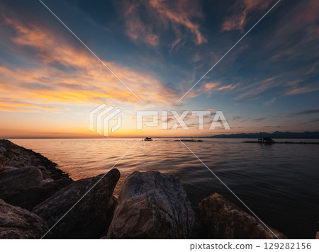 Ocean In The Morning With An Orange Sunlight Above Ocean In The Morning With An Orange Sunlight Above 129282156