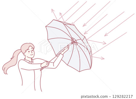 A Woman Gracefully Holding an Umbrella While Enjoying the Bright Sunlight and Warmth 129282217