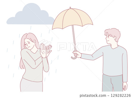 A gentleman protects his lovely companion with an umbrella, showing kindness and chivalry 129282226