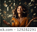 Woman in yellow shirt throwing money 129282291
