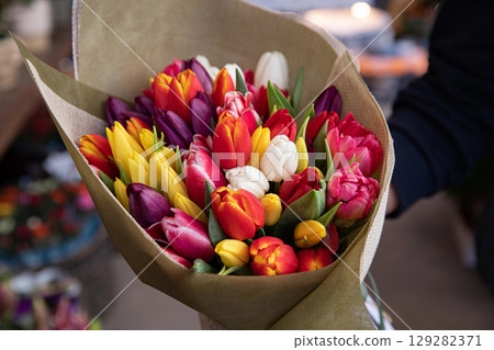 Beautiful bouquet of multi-colored tulips in a flower shop. Horizontal. Close-up. Beautiful bouquet of multi-colored tulips in a flower shop. Horizontal. Close-up. 129282371