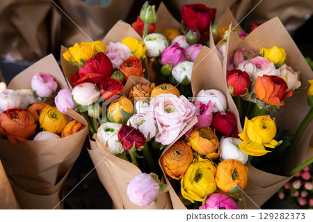 Colorful persian buttercup flowers or Ranunculus asiaticus bouquets in a greek flower shop. Horizontal. Close-up. Colorful persian buttercup flowers or Ranunculus asiaticus bouquets in a greek flower shop. Horizontal. Close-up. 129282373