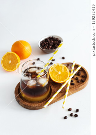 Layered Bumble Coffee with orange and espresso, served in a glass on white table 129282419