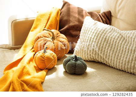 Autumnal living room decor with corduroy pumpkins and cozy pillows. Autumnal living room decor with corduroy pumpkins and cozy pillows. 129282435