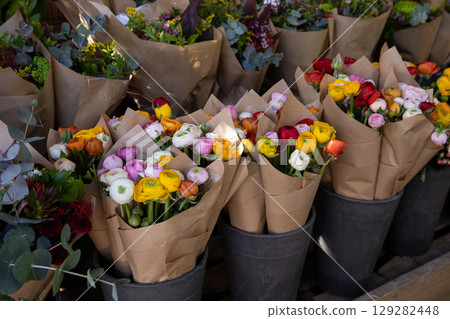 Colorful persian buttercup flowers or Ranunculus asiaticus bouquets in a greek flower shop. Horizontal. Daylight. Colorful persian buttercup flowers or Ranunculus asiaticus bouquets in a greek flower shop. Horizontal. Daylight. 129282448