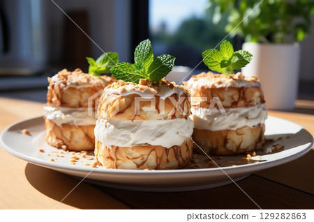 A White Plate Topped With Iced Cronuts. Freshly baked cronut - flaky croissant-doughnut hybrid 129282863