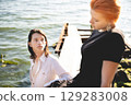 two lovers boy and girl are happy walking and hugging on the sandy beach near the sea. 129283008