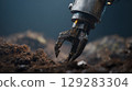 Robotic claw excavating soil: futuristic technology in action 129283304