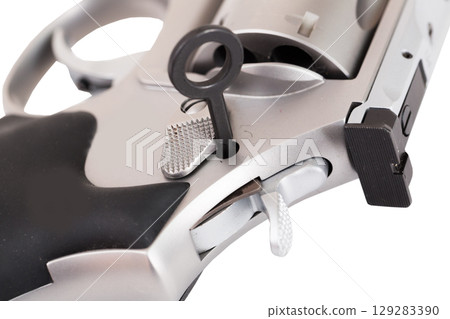 Close-up of revolver with safety lock key inserted Close-up of revolver with safety lock key inserted 129283390