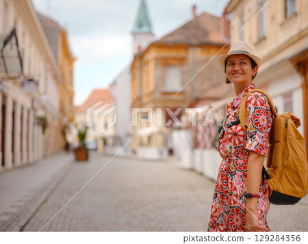Woman Walking Through the Historic Center of Varazdin 129284356