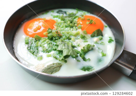 fried egg or sunny side up egg with vegetable topping fried egg or sunny side up egg with vegetable topping 129284602