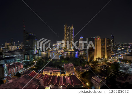 Bangkok, Thailand - December 31, 2022 : Iconsiam shopping mall buildings in the city with water reflection, firework, light show at night time. Bangkok, Thailand - December 31, 2022 : Iconsiam shopping mall buildings in the city with water reflection, firework, light show at night time. 129285022