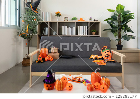 Halloween Decor. A cozy living room filled with festive decorations and pumpkins. Halloween Decor. A cozy living room filled with festive decorations and pumpkins. 129285177