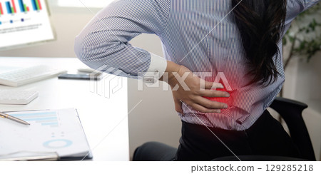 Office Syndrome: Woman Experiencing Back Pain at Work 129285218