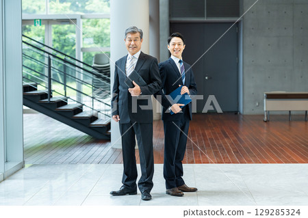 Business people walking down an office corridor Business people walking down an office corridor 129285324